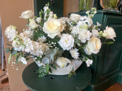 Pure Elegance Arrangement - A timeless arrangement of fresh white seasonal flowers and foliage, beautifully presented in a stylish container. Flowers are dependent on seasonal availability.